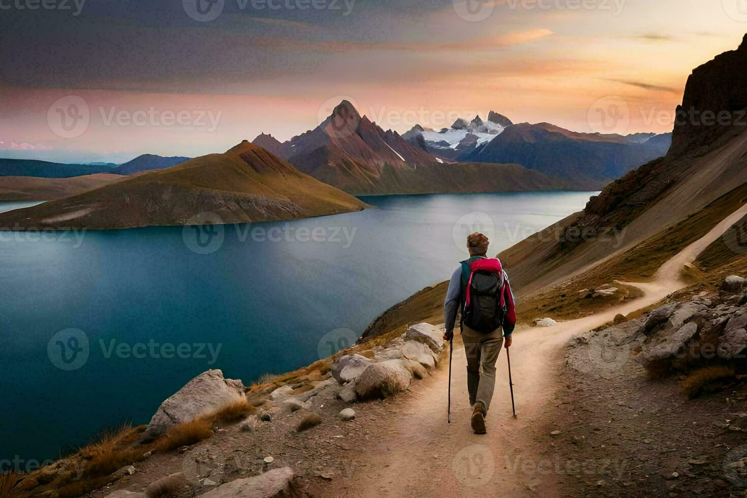 a man with a backpack walks up a mountain trail to a lake. AI-Generated photo