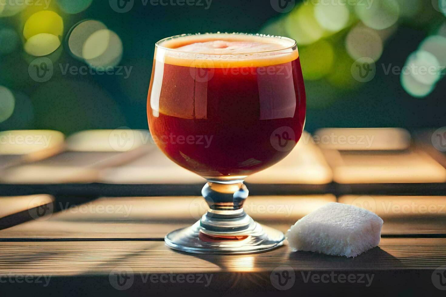 a glass of red juice sitting on a table. AI-Generated photo