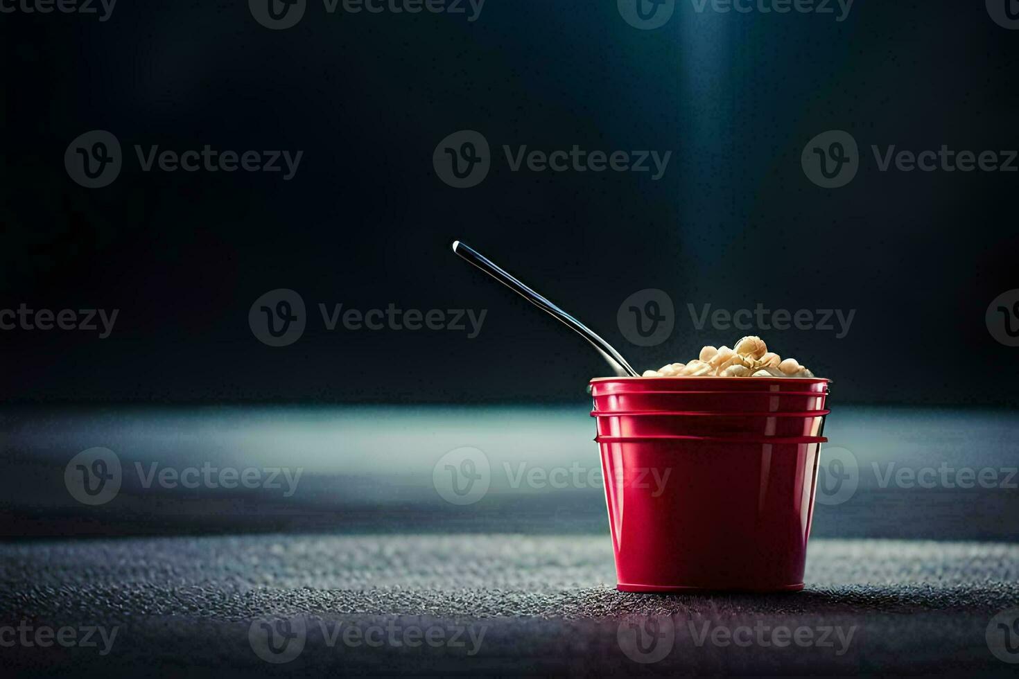 a red cup with a spoon sitting on top of a table. AI-Generated photo