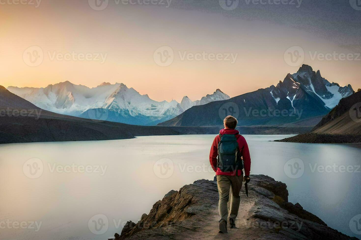 a man standing on a rock overlooking a lake and mountains. AI-Generated photo