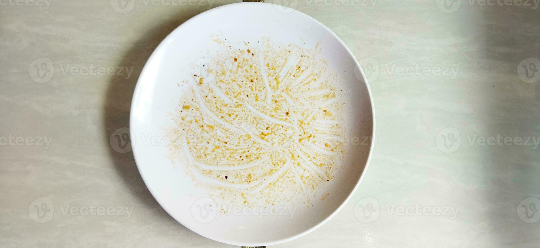Top view of empty plate, dirty after the meal is finished isolate with clipping path, sauce smeared on a plate. photo