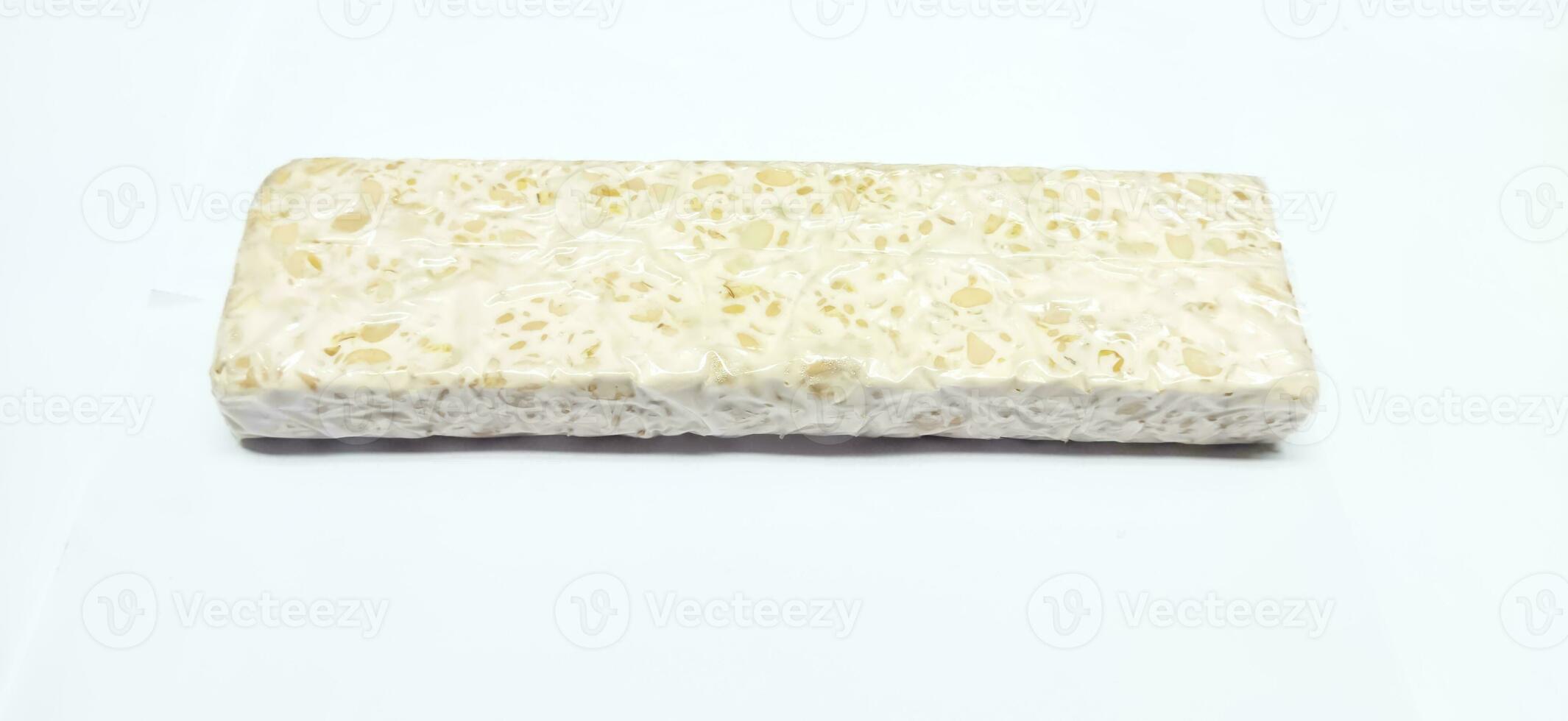 Tempeh or tempe is a typical Indonesian food made from fermented soybeans. tempeh isolated on white background photo