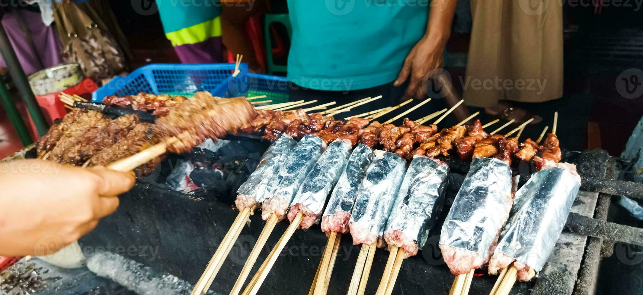 Sate Buntel or Satay Buntel is satay made from minced mutton wrapped in mutton fat is being grilled on charcoal photo