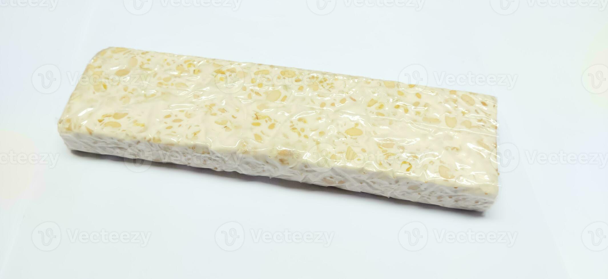 Tempeh or tempe is a typical Indonesian food made from fermented soybeans. tempeh isolated on white background photo