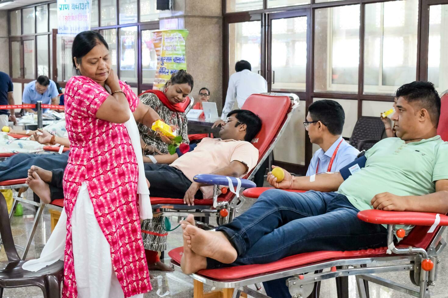 Delhi, India, July 19 2023 - Blood donor at Blood donation camp held at Balaji Temple, Vivek Vihar, Delhi, India, Image for World blood donor day on June 14 every year, Blood Donation Camp at Temple photo