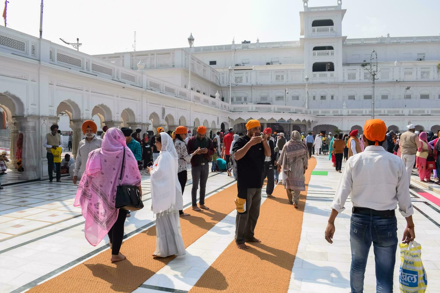 Amritsar, India - February 26 2023 - Unidentified devotees from various parts at Golden Temple Harmandir Sahib in Amritsar, Punjab, India, Famous indian sikh landmark, Golden Temple photo