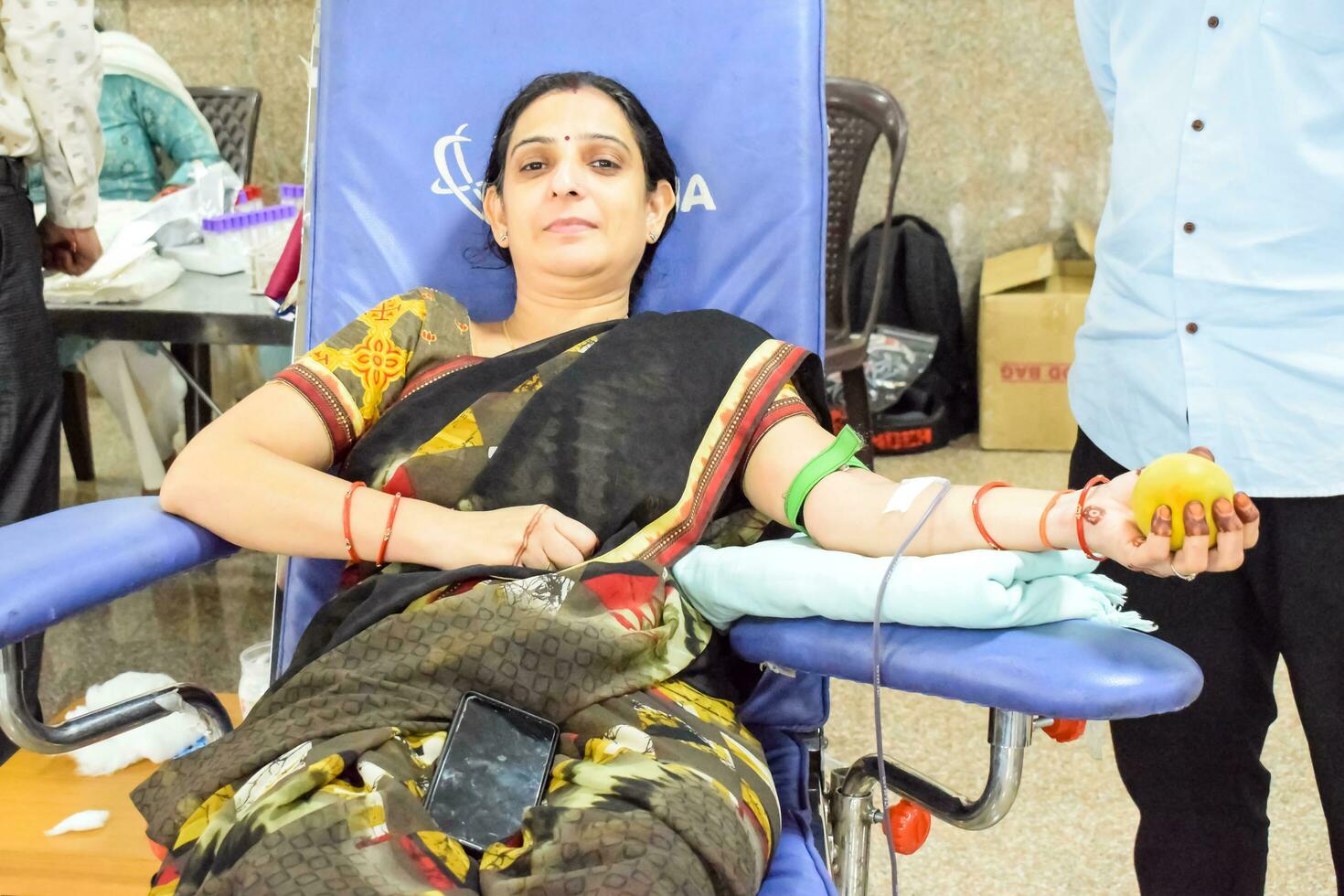 Delhi, India, June 19 2023 - Blood donor at Blood donation camp held at Balaji Temple, Vivek Vihar, Delhi, India, Image for World blood donor day on June 14 every year, Blood Donation Camp at Temple photo