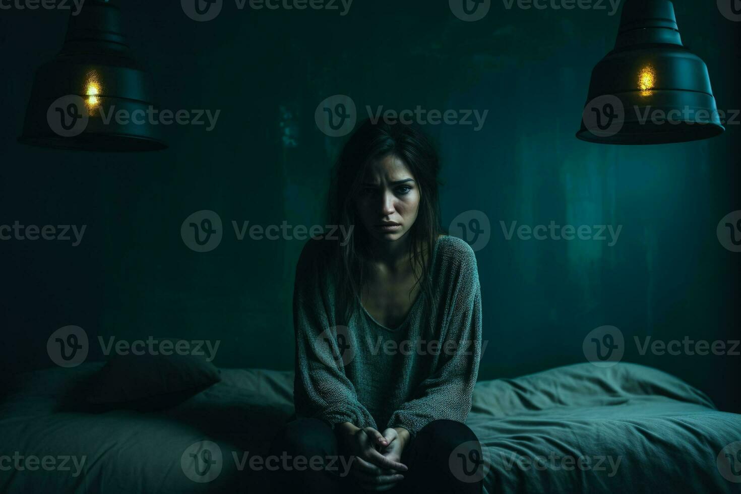 Depressed young woman in dimly lit room isolated on a gradient background photo