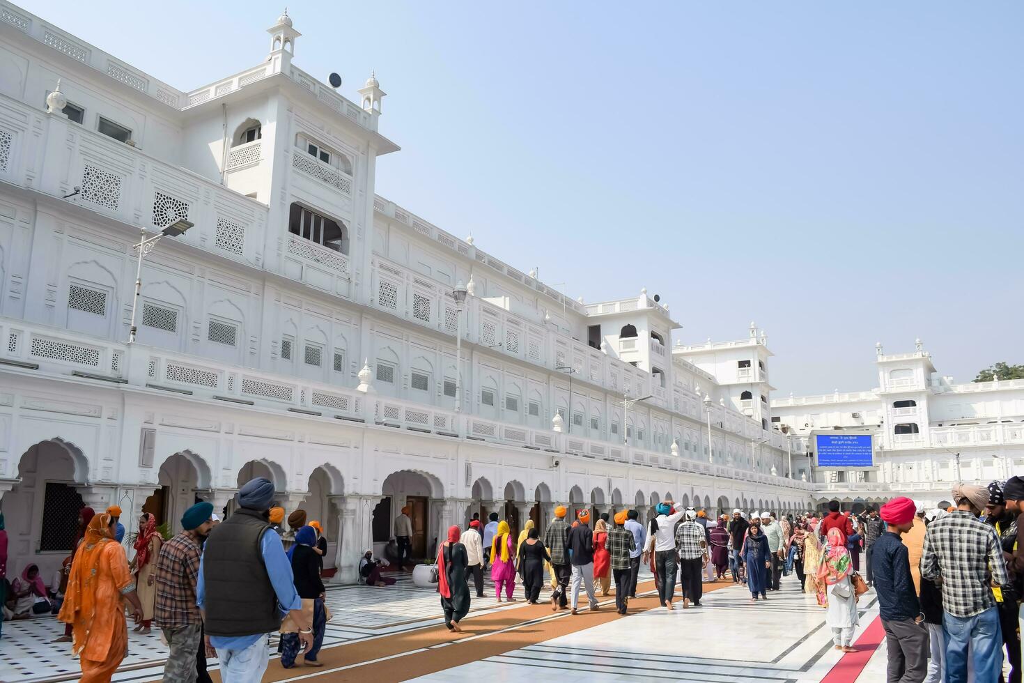 Amritsar, India - February 26 2023 - Unidentified devotees from various parts at Golden Temple Harmandir Sahib in Amritsar, Punjab, India, Famous indian sikh landmark, Golden Temple photo