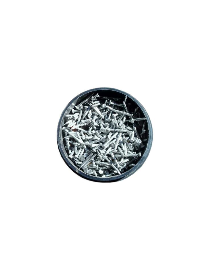 Small metal nails in a black plastic box on a white background photo