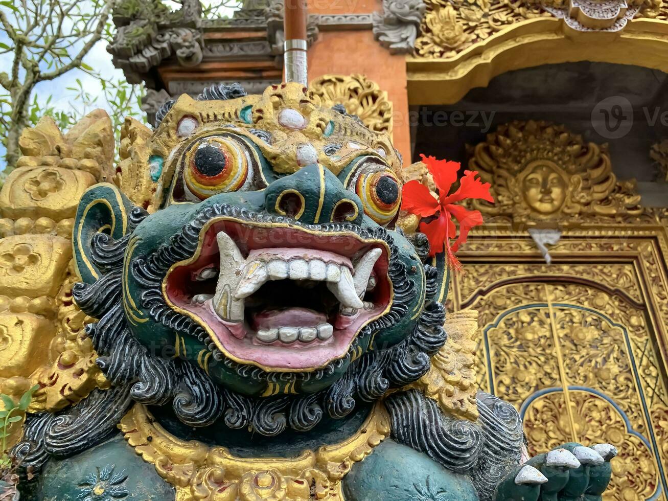 Traditional old ancient Balinese statue of demon angel called barong bali guarding sacred ritual temple photo