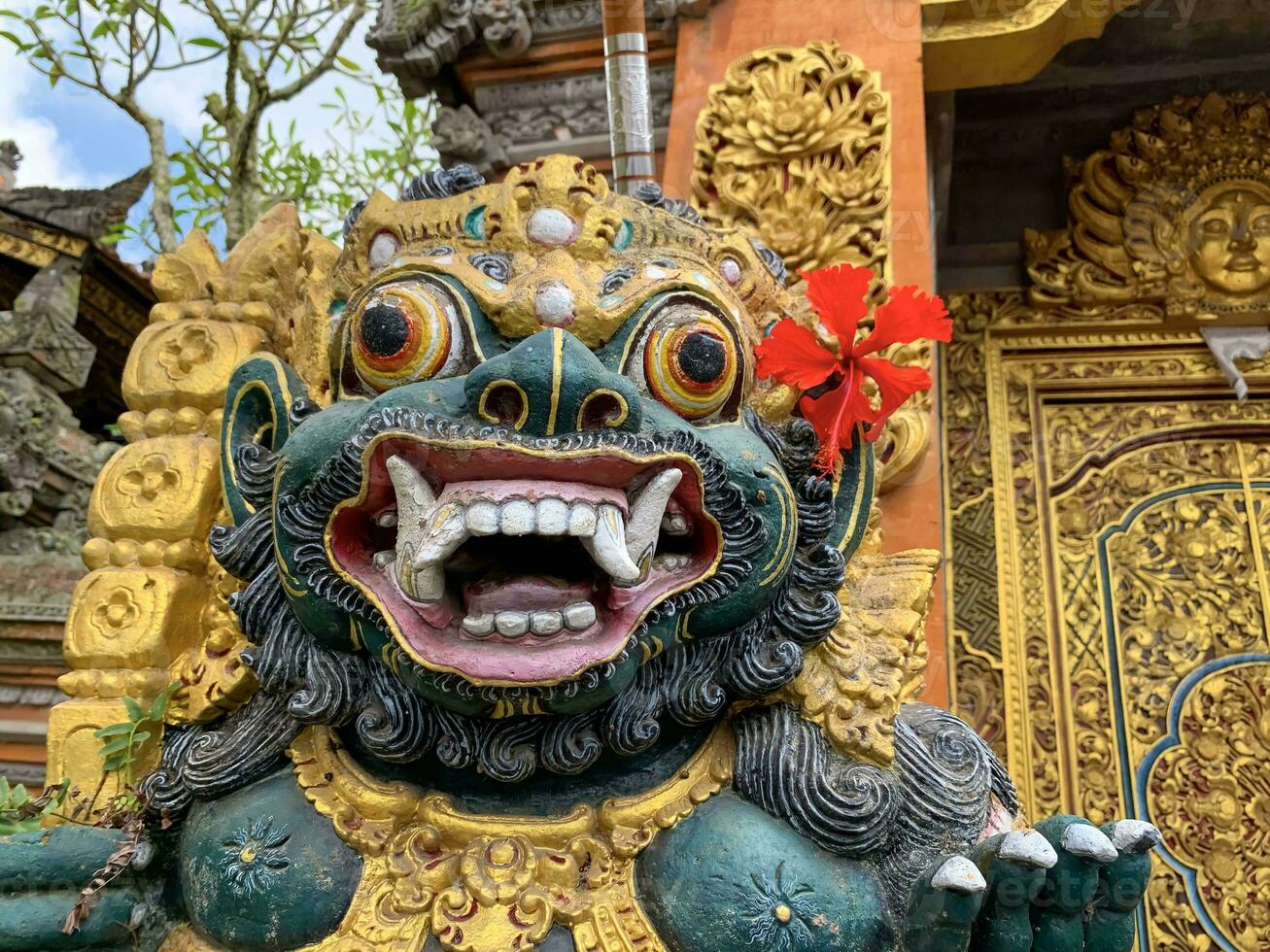 Traditional old ancient Balinese statue of demon angel called barong bali guarding sacred ritual temple photo