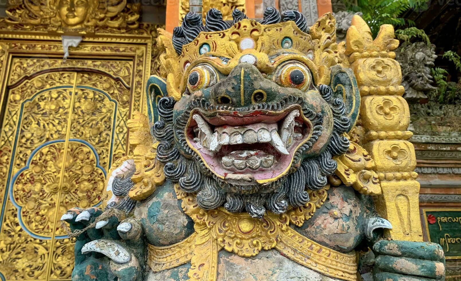 Traditional old ancient Balinese statue of demon angel called barong bali guarding sacred ritual temple photo