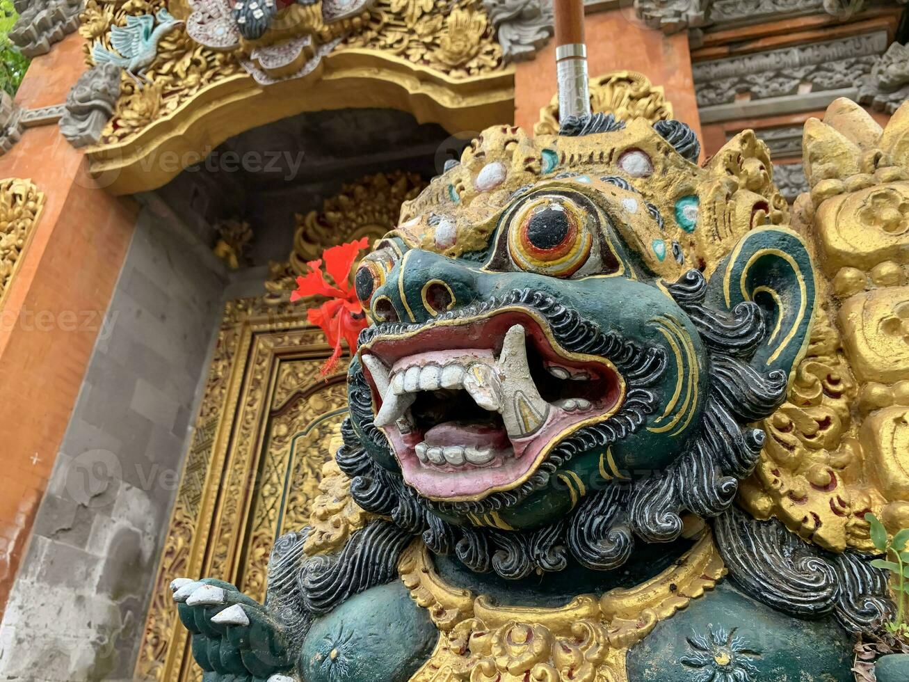 Traditional old ancient Balinese statue of demon angel called barong bali guarding sacred ritual temple photo