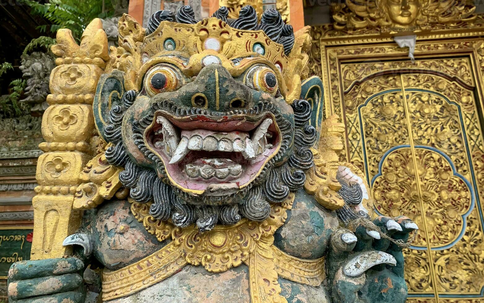 Traditional old ancient Balinese statue of demon angel called barong bali guarding sacred ritual temple photo