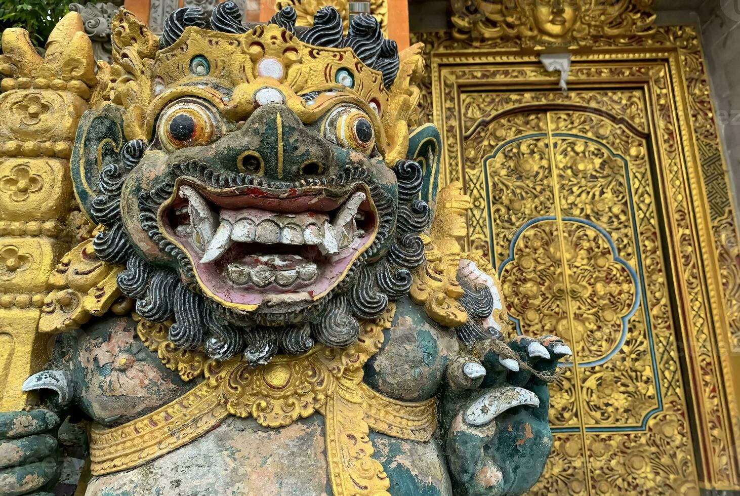 Traditional old ancient Balinese statue of demon angel called barong bali guarding sacred ritual temple photo