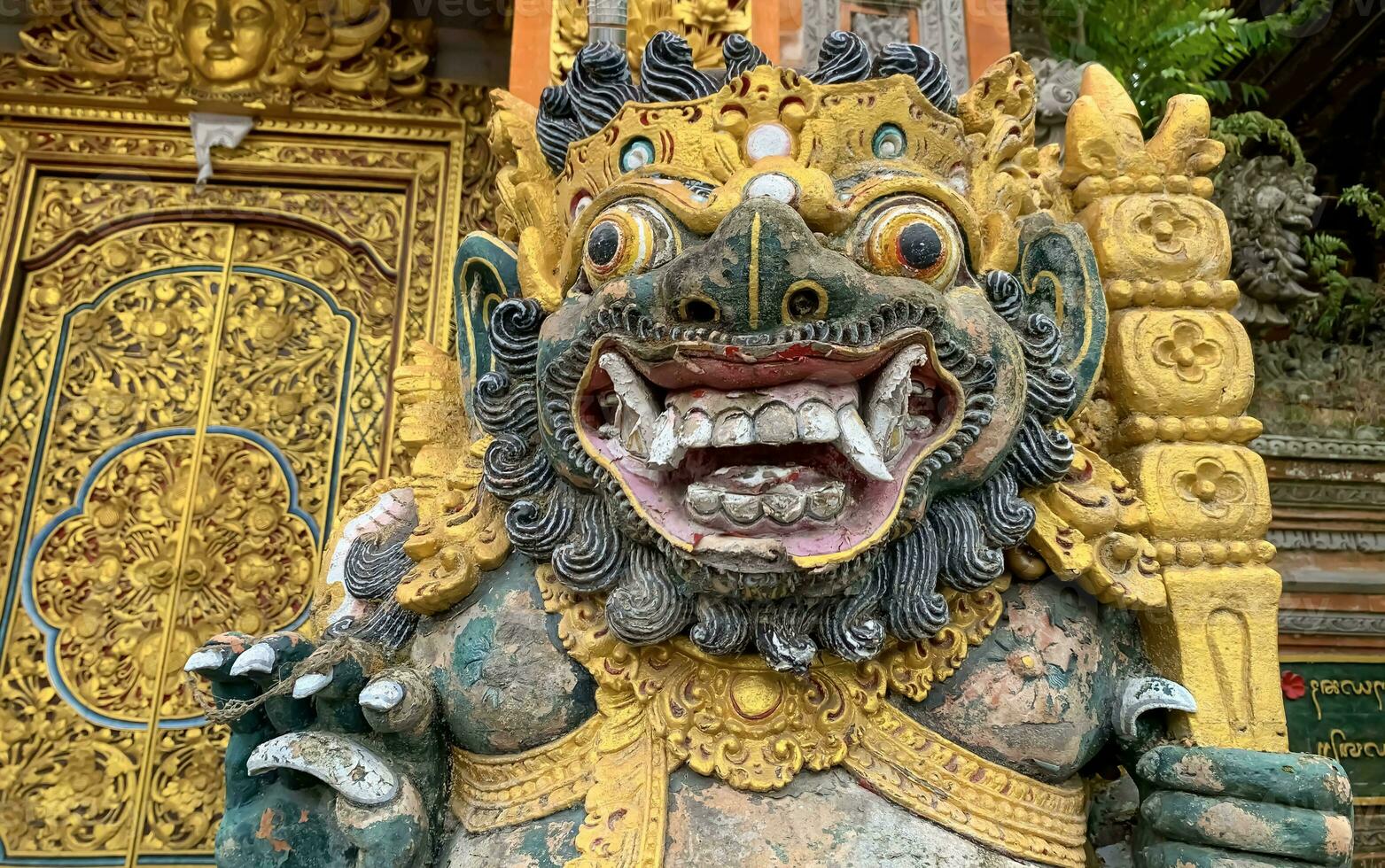 Traditional old ancient Balinese statue of demon angel called barong bali guarding sacred ritual temple photo