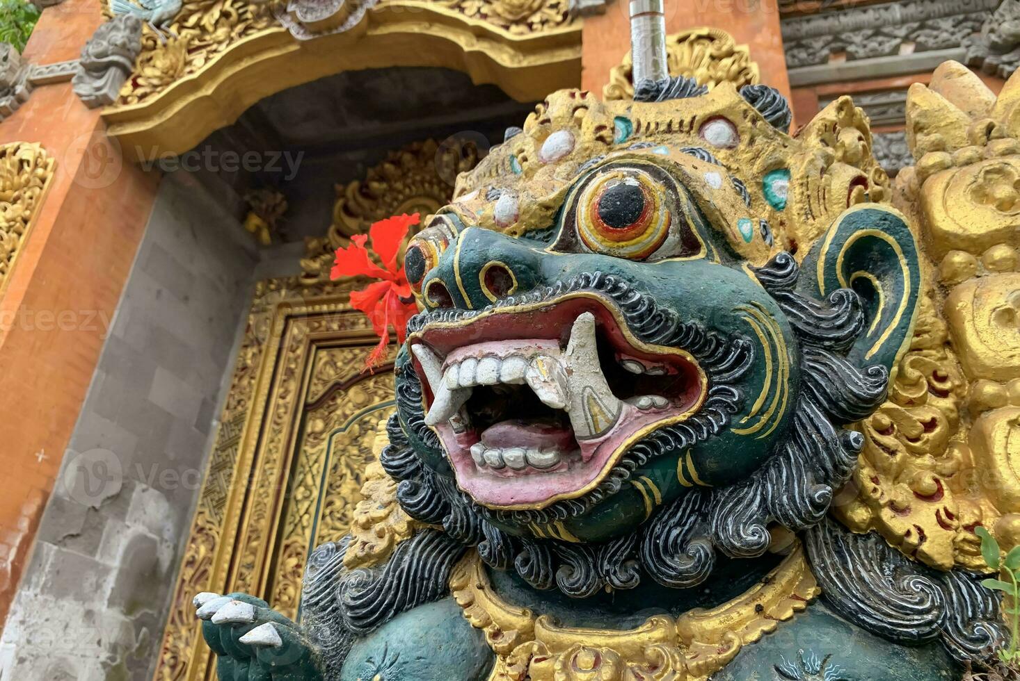 Traditional old ancient Balinese statue of demon angel called barong bali guarding sacred ritual temple photo