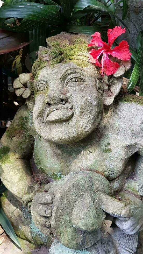 Beautiful artistic Bali stone statue of a Balinese ancient garden statue used as garden decoration, javanese gnome indonesia photo