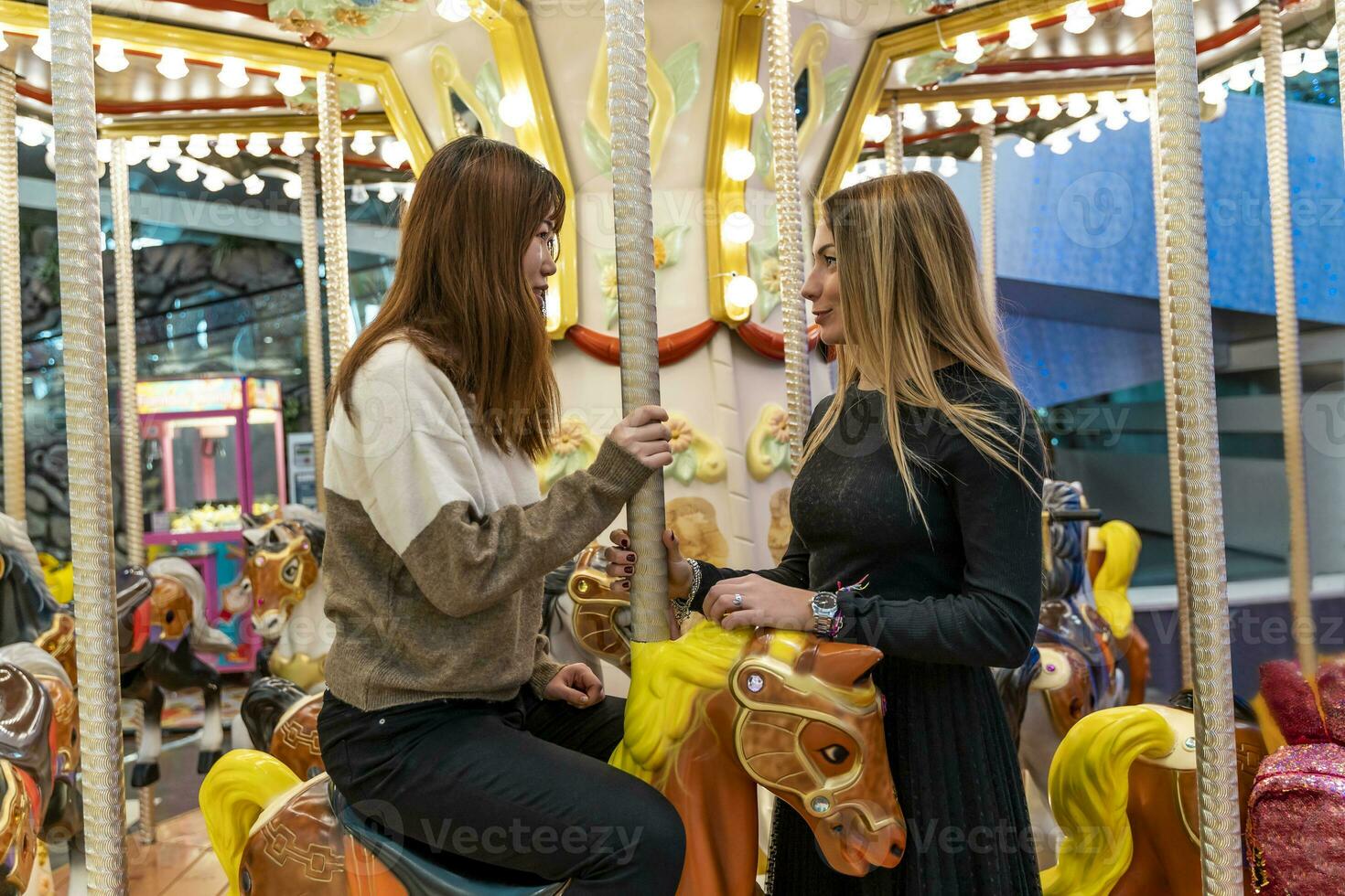 couple of multiethnic young women having fun after shopping photo