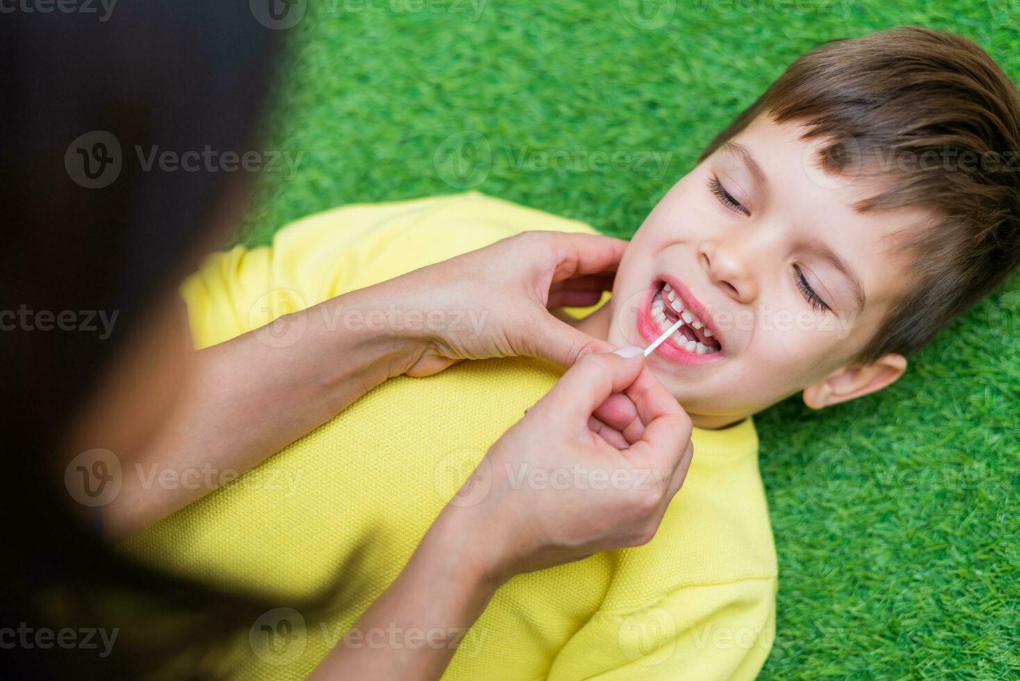 Woman speech therapist helps a child correct the violation of his speech in her office photo