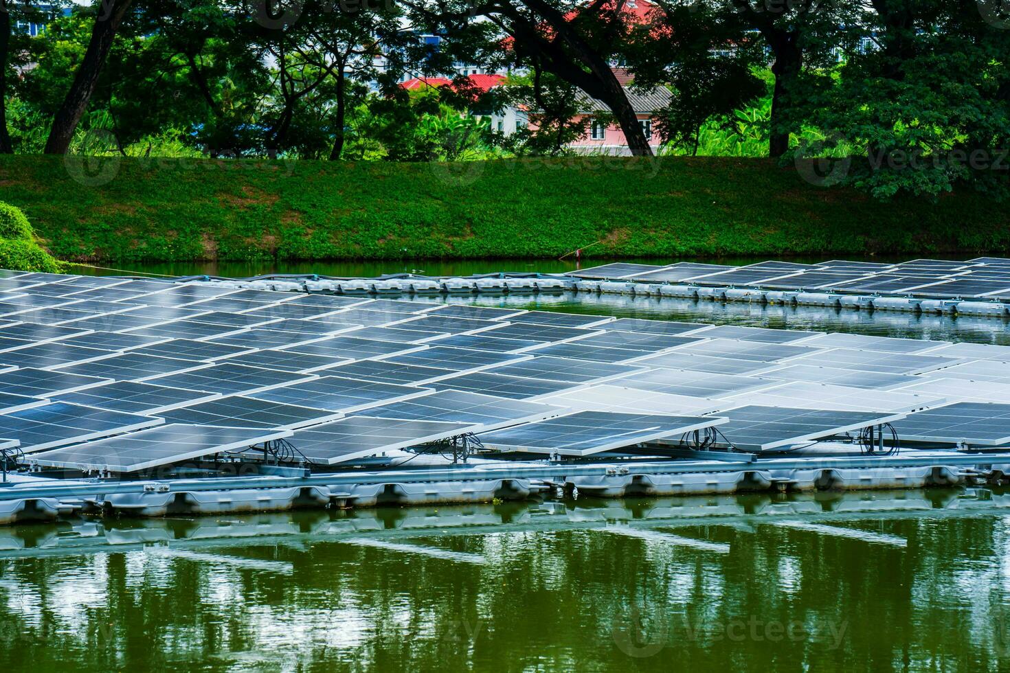 Side view of solar panels floating on water in a lake, for generating electricity from sunlight, selective focus, soft focus. photo