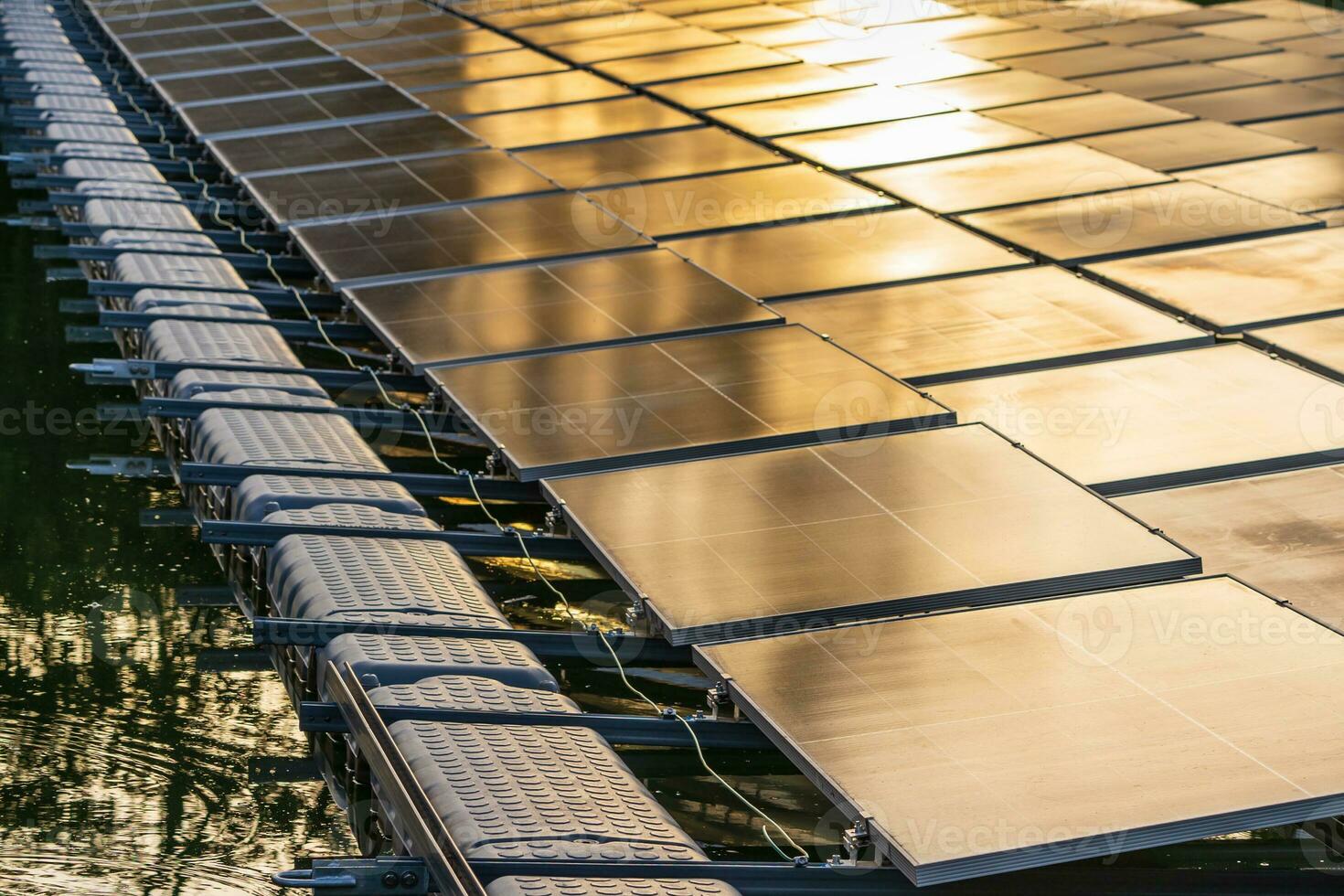 Side view of solar panels floating on water in a lake, for generating electricity from sunlight. photo