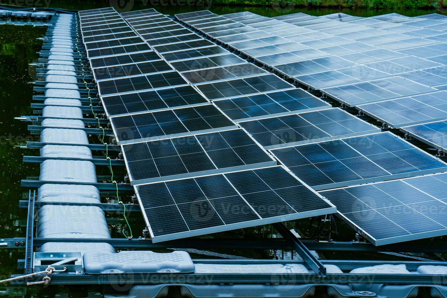Side view of solar panels floating on water in a lake, for generating electricity from sunlight, selective focus, soft focus. photo