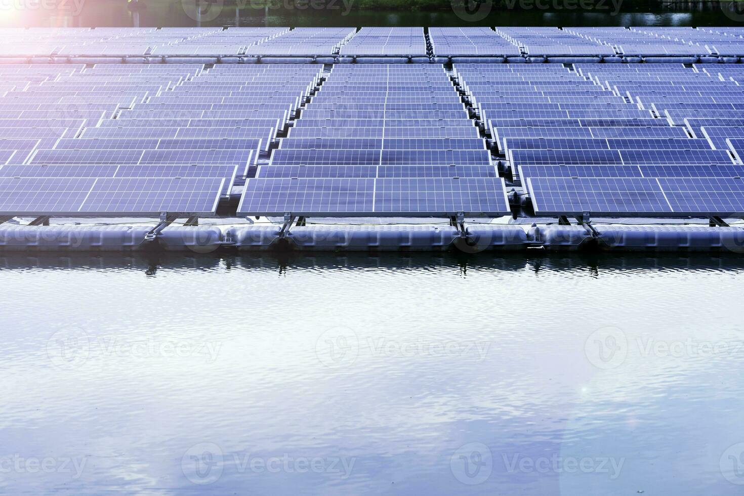 Side view of solar panels floating on water in a lake, for generating electricity from sunlight, selective focus, soft focus. photo