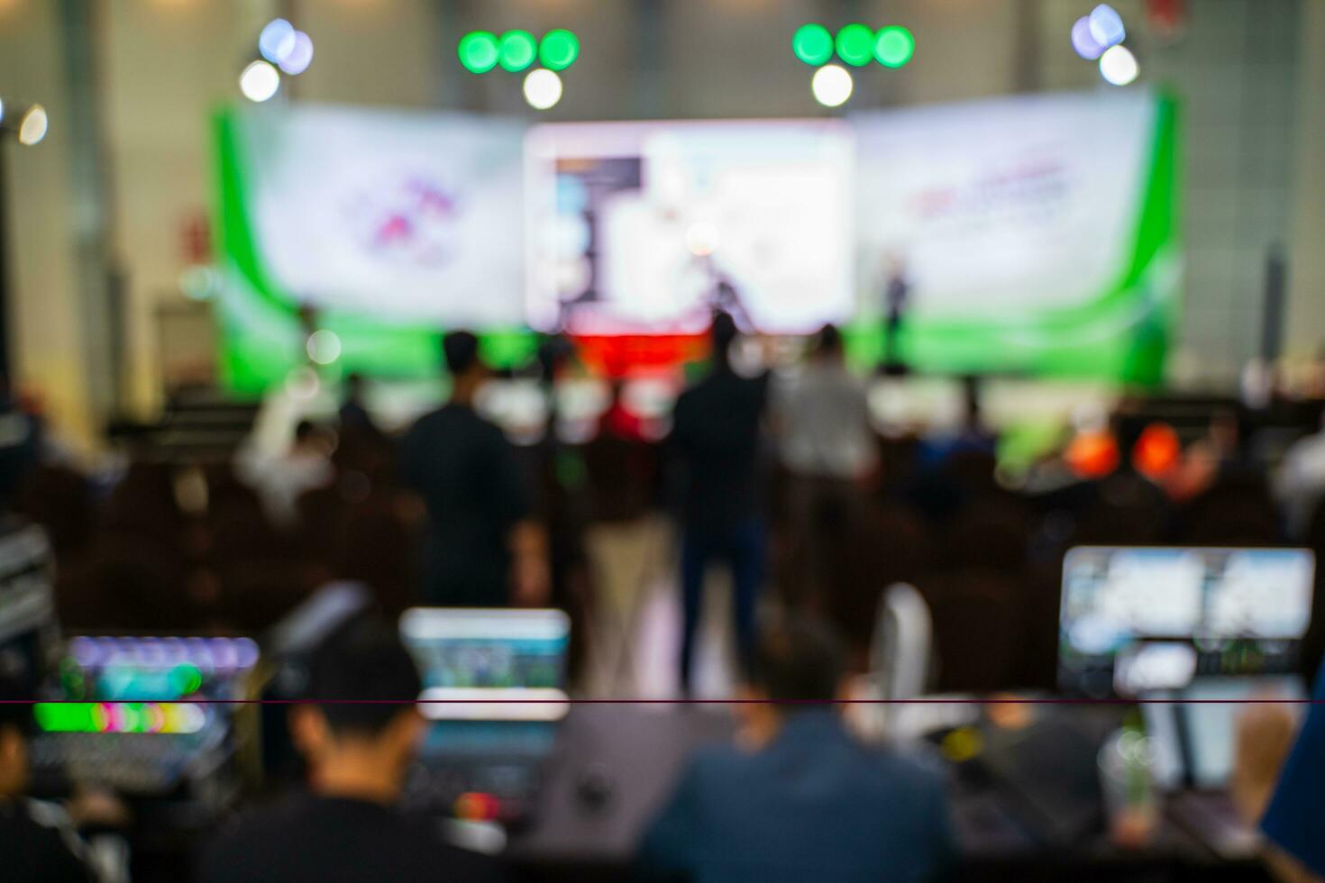 Blurred images of trade fairs in the big hall. image of people walking on a trade fair exhibition or expo where business people show innovation activity and present products in a big hall. photo