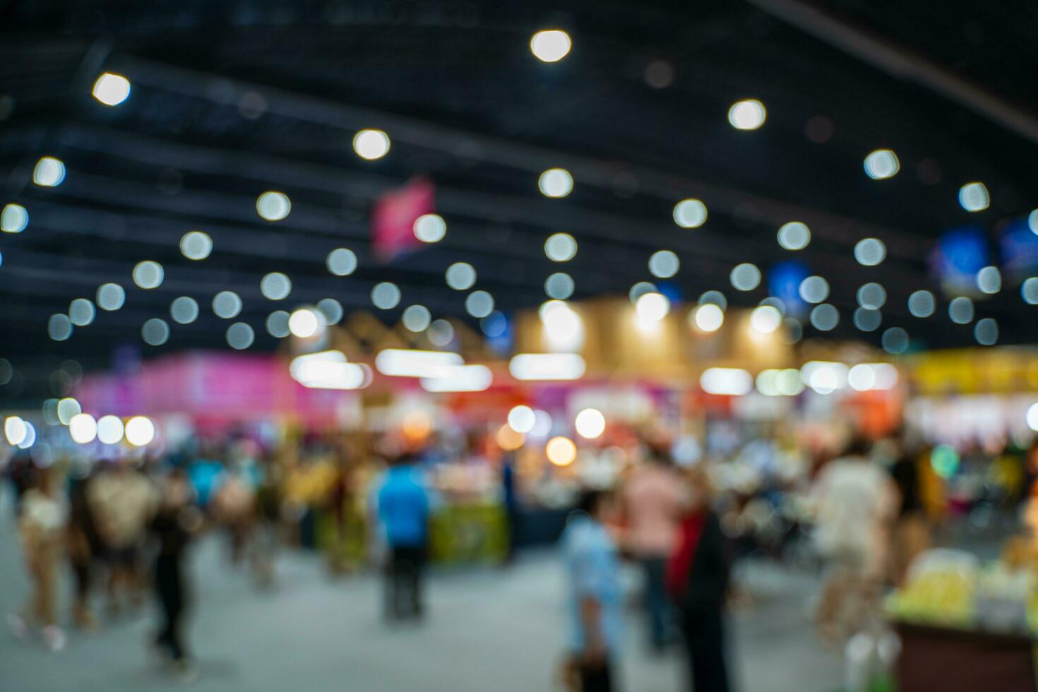 Blurred images of trade fairs in the big hall. image of people walking on a trade fair exhibition or expo where business people show innovation activity and present products in a big hall. photo