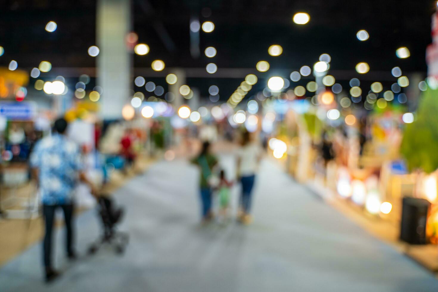 Blurred images of trade fairs in the big hall. image of people walking on a trade fair exhibition or expo where business people show innovation activity and present products in a big hall. photo