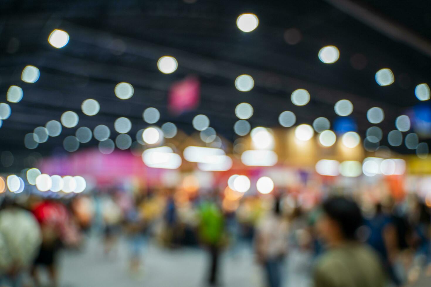 Blurred images of trade fairs in the big hall. image of people walking on a trade fair exhibition or expo where business people show innovation activity and present products in a big hall. photo