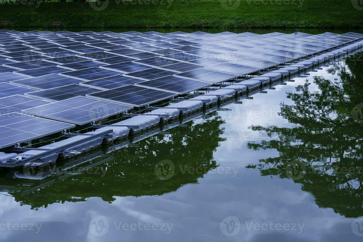 Side view of solar panels floating on water in a lake, for generating electricity from sunlight, selective focus, soft focus. photo