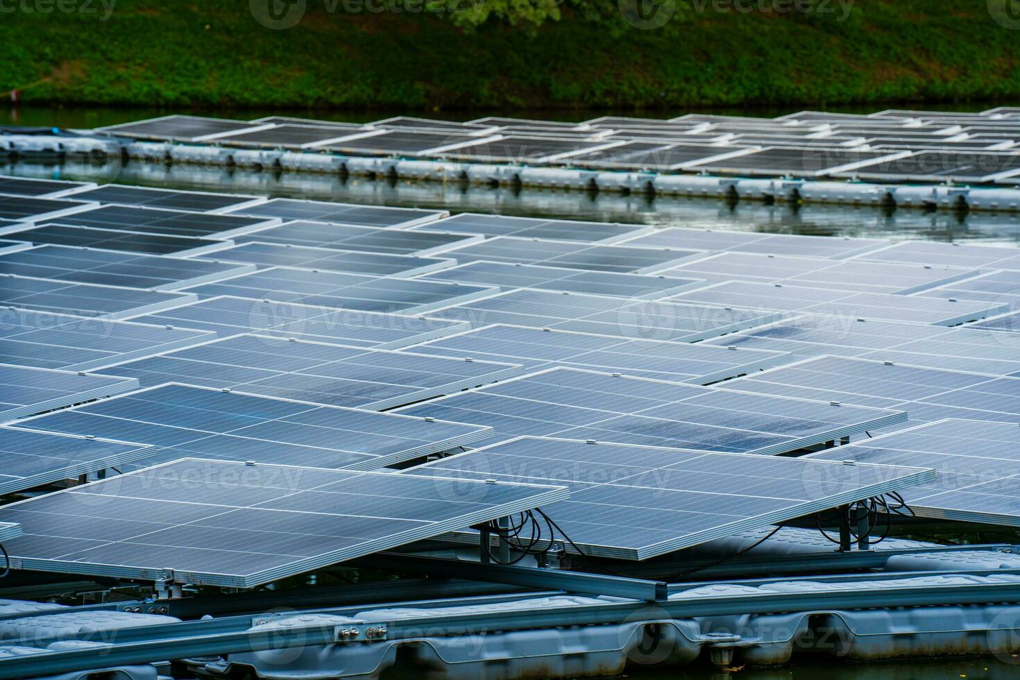 Side view of solar panels floating on water in a lake, for generating electricity from sunlight, selective focus, soft focus. photo