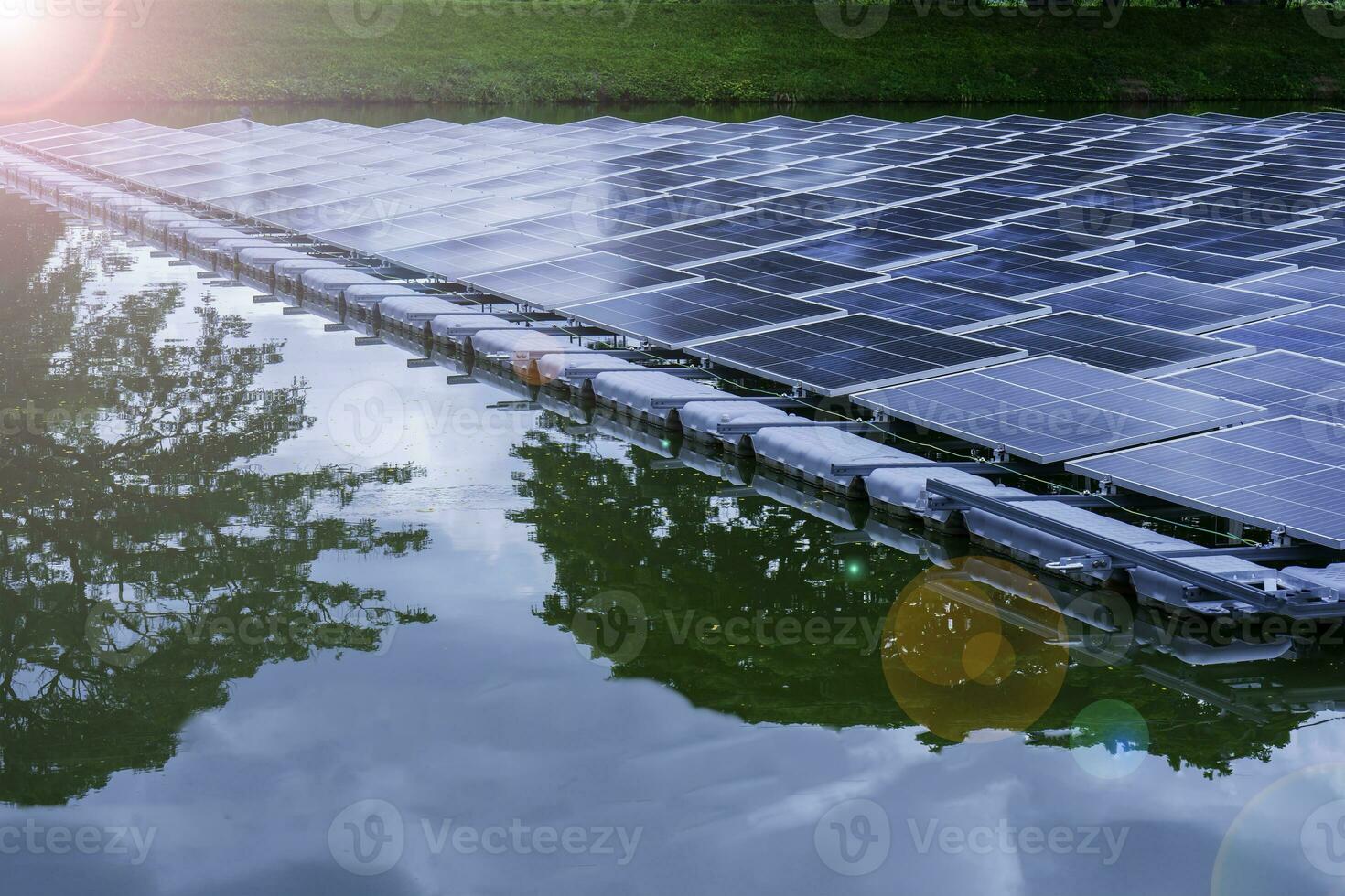 Side view of solar panels floating on water in a lake, for generating electricity from sunlight, selective focus, soft focus. photo