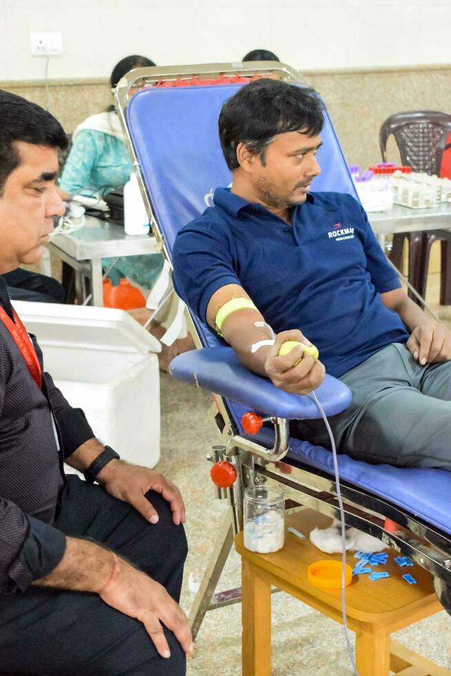 Delhi, India, June 19 2023 - Blood donor at Blood donation camp held at Balaji Temple, Vivek Vihar, Delhi, India, Image for World blood donor day on June 14 every year, Blood Donation Camp at Temple photo