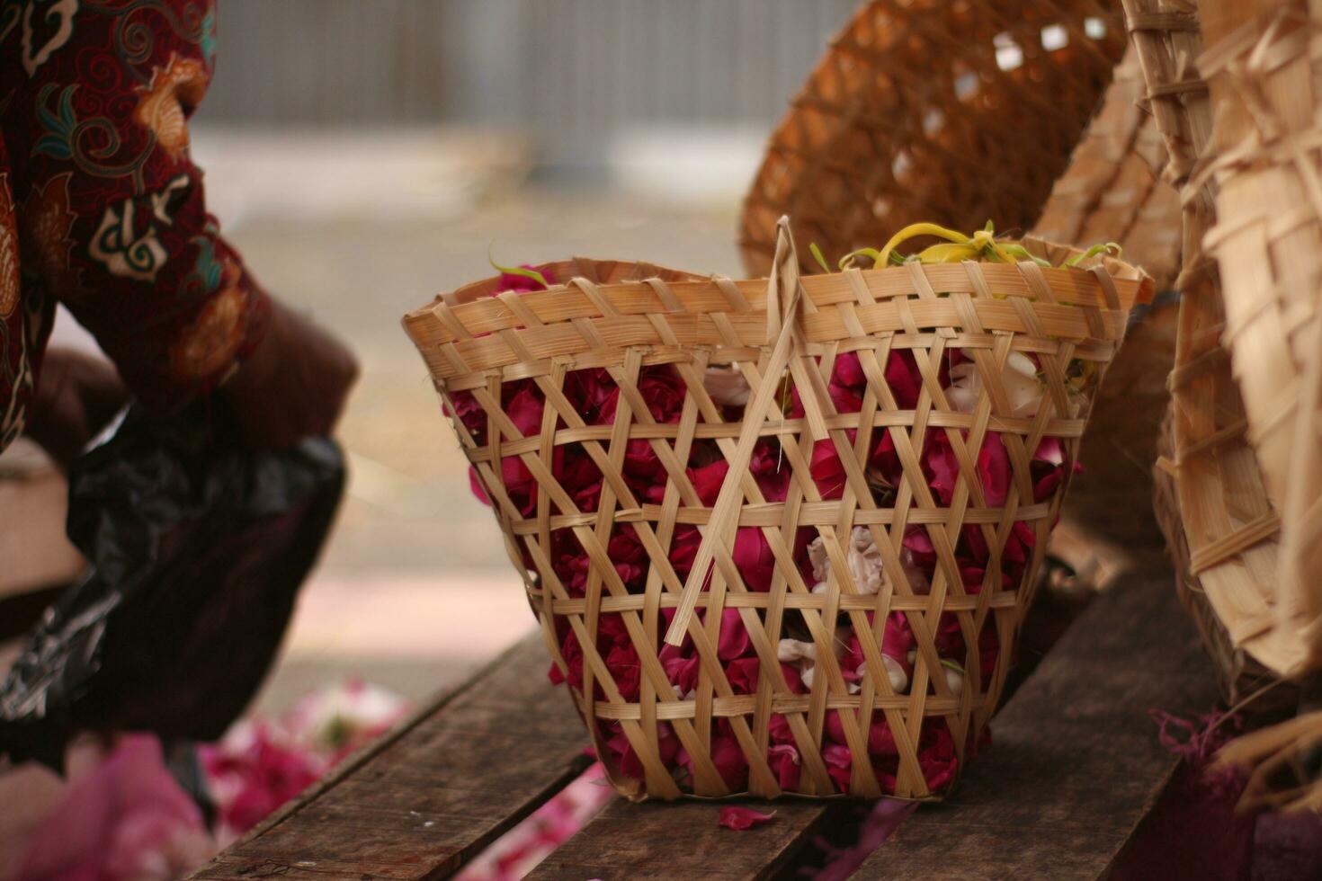 ed roses in wooden baskets are sold on the roadside. photo