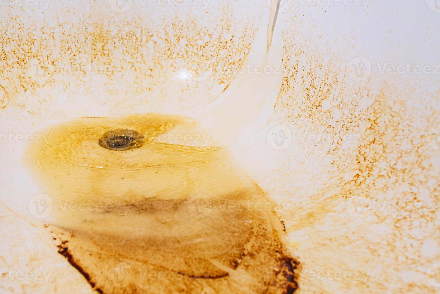 Rusty water flows from the tap into the bathtub 33496952 Stock Photo at