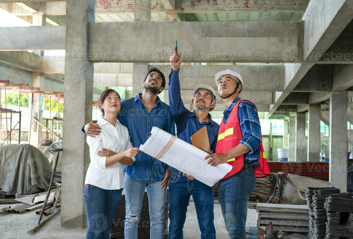 happy family visiting and talking to contractor at site,engineer or architect explain progress of a house building with construction paper to young couple,concept of business,real estate home project photo