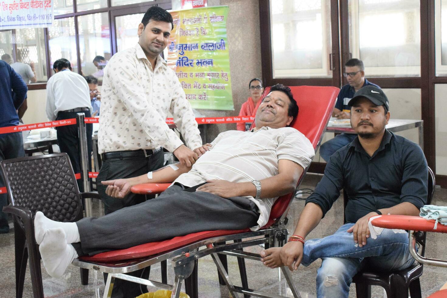 Delhi, India, July 19 2023 - Blood donor at Blood donation camp held at Balaji Temple, Vivek Vihar, Delhi, India, Image for World blood donor day on June 14 every year, Blood Donation Camp at Temple photo