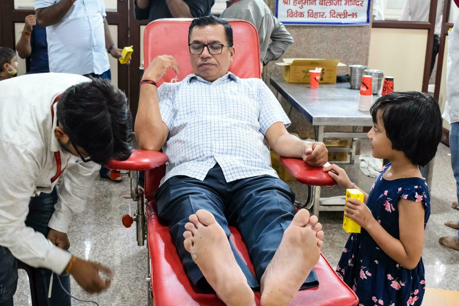 Delhi, India, June 19 2023 - Blood donor at Blood donation camp held at Balaji Temple, Vivek Vihar, Delhi, India, Image for World blood donor day on June 14 every year, Blood Donation Camp at Temple photo