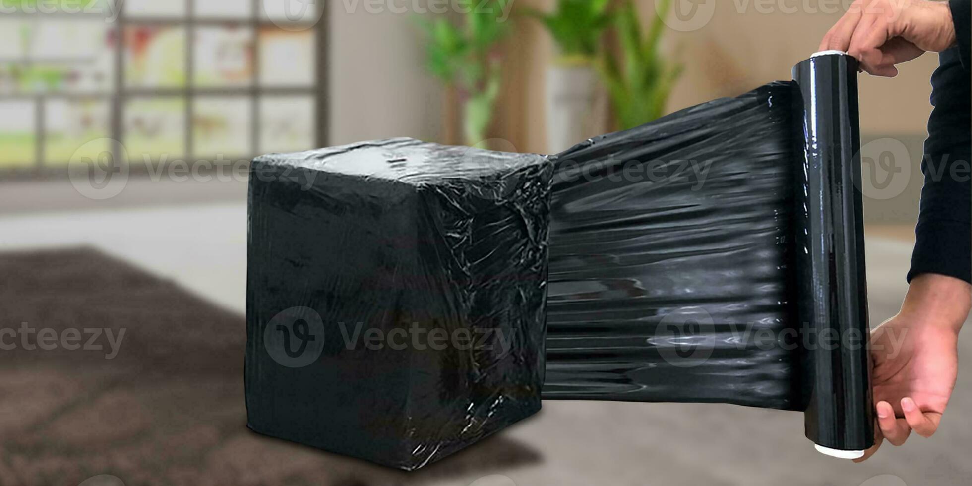 Black pallet shrink wrapped on shipping mystery box with room background photo