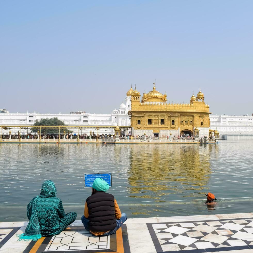 Amritsar, India - February 26 2023 - Unidentified devotees from various parts at Golden Temple Harmandir Sahib in Amritsar, Punjab, India, Famous indian sikh landmark, Golden Temple photo