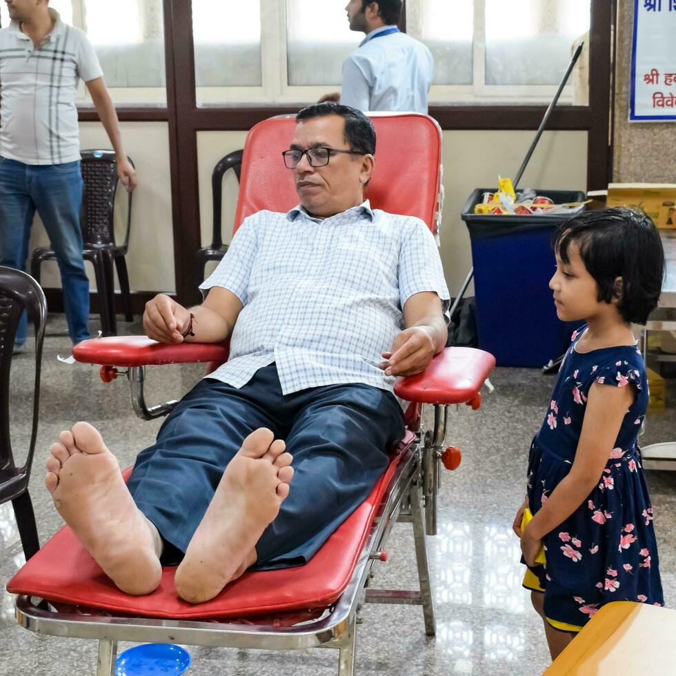 Delhi, India, June 19 2023 - Blood donor at Blood donation camp held at Balaji Temple, Vivek Vihar, Delhi, India, Image for World blood donor day on June 14 every year, Blood Donation Camp at Temple photo