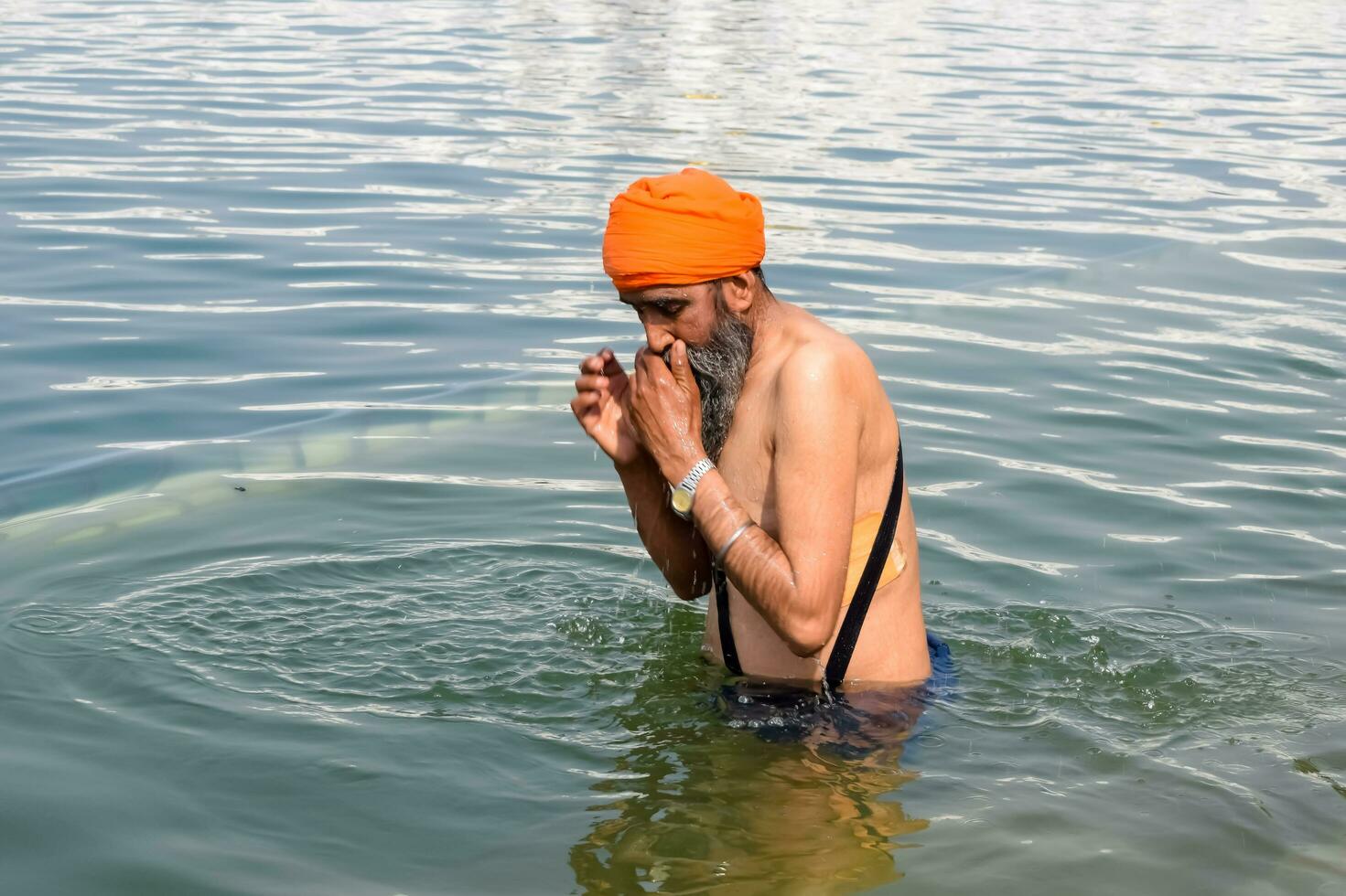 Amritsar, India - February 26 2023 - Unidentified devotees from various parts at Golden Temple Harmandir Sahib in Amritsar, Punjab, India, Famous indian sikh landmark, Golden Temple photo