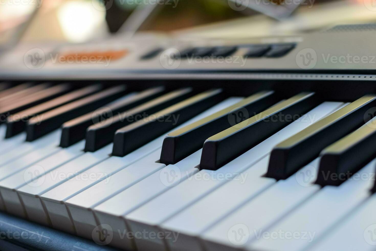 Close-up of piano keys. Piano black and white keys and Piano keyboard musical instrument placed at the home balcony during sunny day. photo