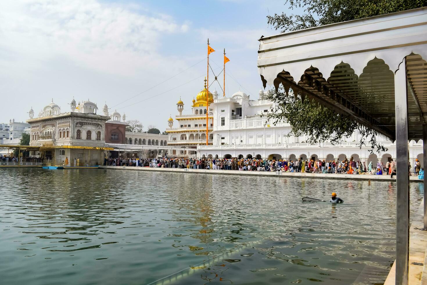 Amritsar, India - February 26 2023 - Unidentified devotees from various parts at Golden Temple Harmandir Sahib in Amritsar, Punjab, India, Famous indian sikh landmark, Golden Temple photo
