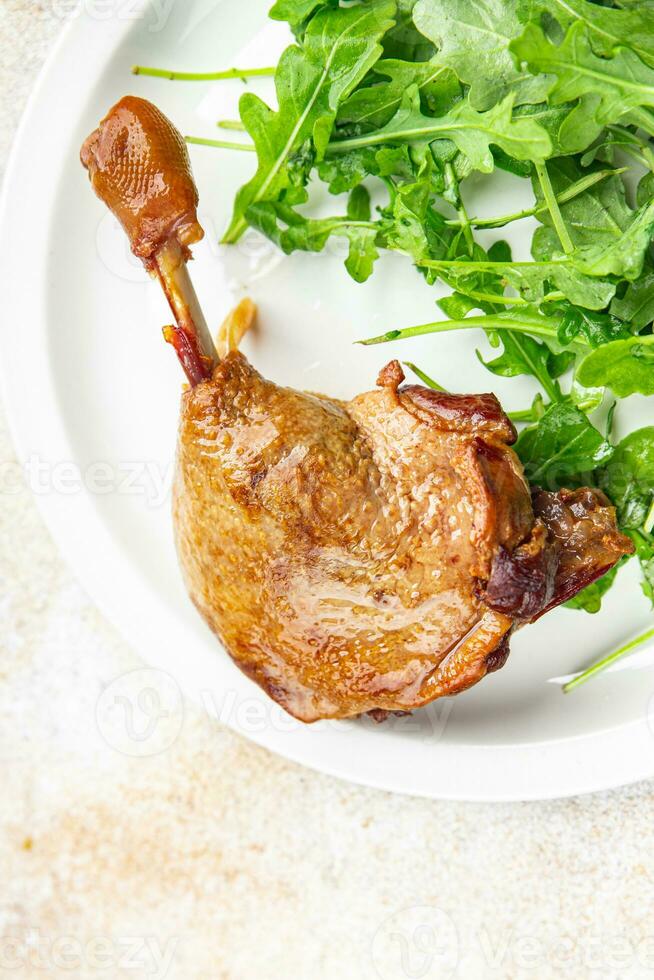 duck leg confit berry sauce poultry meat eating cooking appetizer meal food snack on the table photo
