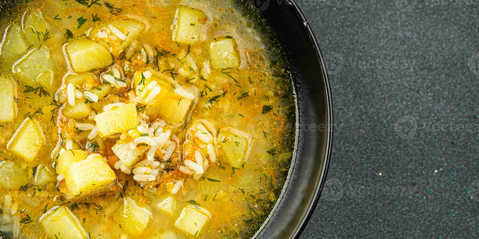 soup vegetable rice broth, potatoe, carrot, onion healthy eating cooking meal food snack on the table copy space food background rustic top view photo